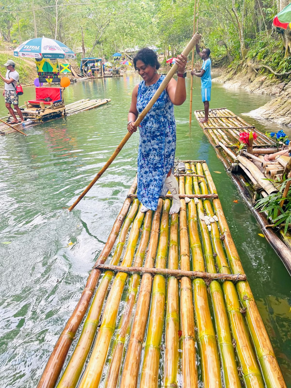 Guest enjoying a bamboo rafting experience on a calm Jamaican river